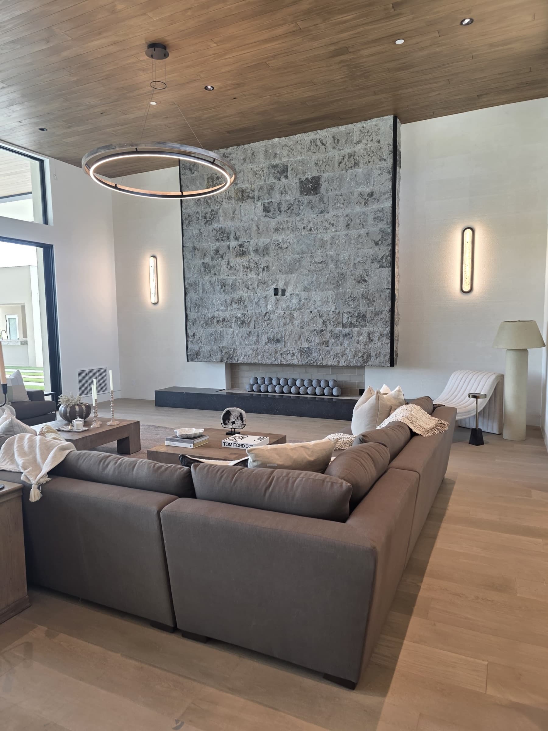 Completed stone fireplace and interior finish project by V Construction